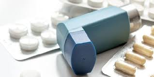 Handful of conventional asthma inhalers and medications representing standard respiratory care